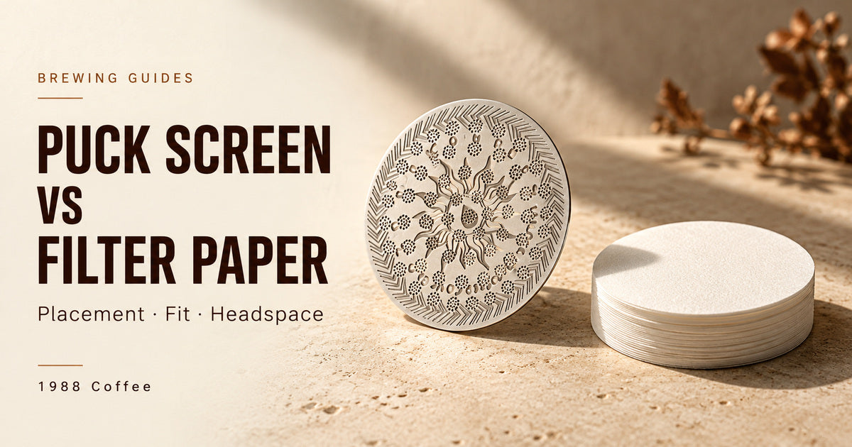 Illustrated stainless espresso puck screen beside a stack of round white filter papers